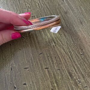 New with tag and jewelry pouch. Hinged gold and silver hinged bracelet